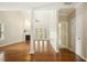 Bright and open living room featuring hardwood floors, fireplace, and glass doors leading to outdoor space at 1515 Poets Glade Dr, Apex, NC 27523
