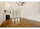 Bright living room features hardwood floors, fireplace, and large windows at 1515 Poets Glade Dr, Apex, NC 27523