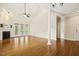 Large living room offers high ceilings, hardwood flooring, fireplace, and French doors to outside at 1515 Poets Glade Dr, Apex, NC 27523