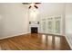 Bright living room features hardwood floors, fireplace, and large windows at 1515 Poets Glade Dr, Apex, NC 27523