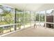 Light-filled sunroom featuring walls of windows with beautiful views of trees and a small lake at 1515 Poets Glade Dr, Apex, NC 27523