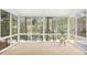 Bright sunroom with large windows providing a scenic view of the water and surrounding trees at 1515 Poets Glade Dr, Apex, NC 27523