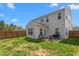 Expansive backyard with patio area, outdoor furniture, grill, and well-maintained lawn for relaxation and entertainment at 1725 Langlais Dr, Graham, NC 27253