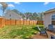 Beautiful backyard with wood fence, lush green grass, and comfortable seating, perfect for outdoor enjoyment at 1725 Langlais Dr, Graham, NC 27253
