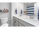 Bright bathroom featuring a double sink vanity with light countertops and modern fixtures at 1725 Langlais Dr, Graham, NC 27253