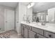Well-lit bathroom featuring double sinks, modern fixtures, and a spacious shower in neutral, calming tones at 1725 Langlais Dr, Graham, NC 27253