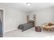 A minimalist bedroom featuring a bed with wooden shelf accents and a papasan chair at 1725 Langlais Dr, Graham, NC 27253