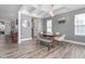 Bright dining room with coffered ceiling, modern lighting, and wood laminate flooring at 1725 Langlais Dr, Graham, NC 27253