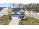 Two story home with a two car garage, covered porch, and neatly maintained front lawn at 1725 Langlais Dr, Graham, NC 27253