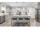 Bright kitchen featuring an island with seating, granite counters, and stainless appliances at 1725 Langlais Dr, Graham, NC 27253