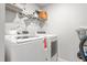 The laundry room features a modern washer and dryer with ample shelf space above at 1725 Langlais Dr, Graham, NC 27253