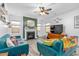 Sunlit living room offers a fireplace, cozy seating, and a ceiling fan, creating a relaxing atmosphere at 1725 Langlais Dr, Graham, NC 27253