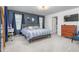 Cozy bedroom with accent wall, carpet, and ample natural light from multiple windows at 1725 Langlais Dr, Graham, NC 27253
