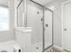 The bathroom has a glass-enclosed shower stall featuring white tiling and modern fixtures at 1725 Langlais Dr, Graham, NC 27253