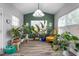 Plant filled sunroom featuring a variety of houseplants, natural light, and cozy seating at 1725 Langlais Dr, Graham, NC 27253