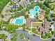 Aerial view of community pool, playgrounds, and clubhouse with parking at 173 Hawk Point Rd, Chapel Hill, NC 27516