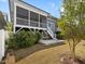 Serene backyard featuring a screened-in porch, patio, and a lush green lawn at 173 Hawk Point Rd, Chapel Hill, NC 27516