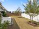 Spacious fenced backyard with healthy grass, landscaping, and concrete patio at 173 Hawk Point Rd, Chapel Hill, NC 27516