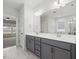 Bathroom featuring a double vanity, expansive mirror, marble tile flooring with views into bedroom at 173 Hawk Point Rd, Chapel Hill, NC 27516