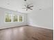 Light filled bedroom featuring a ceiling fan, hardwood floors and large windows at 173 Hawk Point Rd, Chapel Hill, NC 27516