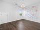 Bedroom with hardwood floors, accent wall and modern lighting fixture at 173 Hawk Point Rd, Chapel Hill, NC 27516