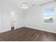 Bedroom with hardwood floors, modern lighting fixture and view of large walk-in closet at 173 Hawk Point Rd, Chapel Hill, NC 27516