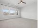 Bedroom with carpet, ceiling fan, and three large windows allowing in plenty of natural light at 173 Hawk Point Rd, Chapel Hill, NC 27516