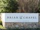 Elegant community sign for Briar Chapel by Newland Communities, set amidst natural stone and greenery at 173 Hawk Point Rd, Chapel Hill, NC 27516