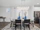 Dining area with a modern chandelier and a view to the living space, creating an inviting atmosphere for meals at 173 Hawk Point Rd, Chapel Hill, NC 27516