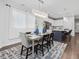 The dining room features hardwood floors, a modern chandelier, and is adjacent to the kitchen and kitchen island at 173 Hawk Point Rd, Chapel Hill, NC 27516