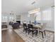 Elegant dining area with decorative lighting, an adjacent living room and a view of the fireplace, perfect for entertaining guests at 173 Hawk Point Rd, Chapel Hill, NC 27516