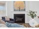 Close up of the fireplace with hearth, gas logs and beautiful tree painting above at 173 Hawk Point Rd, Chapel Hill, NC 27516