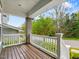 Inviting front porch with white railings and wooden floor, offering a serene outdoor space at 173 Hawk Point Rd, Chapel Hill, NC 27516