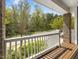 Inviting front porch with white railings and wooden floor, offering a serene outdoor space at 173 Hawk Point Rd, Chapel Hill, NC 27516