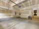 Spacious garage with concrete floors, utility access, and storage racks; ready for customization at 173 Hawk Point Rd, Chapel Hill, NC 27516