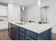 Kitchen island with a sink and countertop seating, blending functionality with modern design and open to other rooms at 173 Hawk Point Rd, Chapel Hill, NC 27516