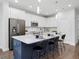 Stylish kitchen island with seating, quartz countertop, and stainless steel appliances, offering a great space for cooking and entertaining at 173 Hawk Point Rd, Chapel Hill, NC 27516