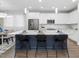 Kitchen island featuring countertop seating, modern pendant lighting, and an open view to the dining and living areas at 173 Hawk Point Rd, Chapel Hill, NC 27516