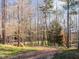 Picturesque landscaping with wooden fence and lush green lawn, blending nature and property charm at 173 Hawk Point Rd, Chapel Hill, NC 27516