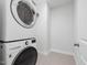 Bright laundry room featuring a stackable washer and dryer at 173 Hawk Point Rd, Chapel Hill, NC 27516