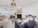 The living room features hardwood floors, lots of natural light, a ceiling fan and a gas fireplace at 173 Hawk Point Rd, Chapel Hill, NC 27516