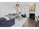 The living room features hardwood floors, lots of natural light, a ceiling fan and a gas fireplace at 173 Hawk Point Rd, Chapel Hill, NC 27516