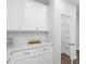 Bright white kitchen with tile backsplash and a walk-in pantry featuring adjustable shelving for organized storage at 173 Hawk Point Rd, Chapel Hill, NC 27516