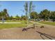 Fun community playground with seesaw, swing, basketball court, and shaded seating area for residents at 173 Hawk Point Rd, Chapel Hill, NC 27516