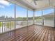 The screened porch features wood flooring, a ceiling fan and views of the fenced back yard at 173 Hawk Point Rd, Chapel Hill, NC 27516