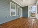 This view of the screened porch features wood flooring and access to the back yard at 173 Hawk Point Rd, Chapel Hill, NC 27516