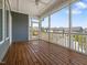 The screened porch features wood flooring, a ceiling fan and views of the neighborhood at 173 Hawk Point Rd, Chapel Hill, NC 27516