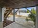 View of patio area under decking, showing stairs to the yard area and fence at 173 Hawk Point Rd, Chapel Hill, NC 27516