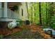 Property featuring a lush backyard with mature trees and a storage tank at 18 Green Ridge Ln, Pittsboro, NC 27312