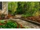 Beautiful backyard featuring a stone pathway and lush greenery, creating a serene and natural oasis at 18 Green Ridge Ln, Pittsboro, NC 27312